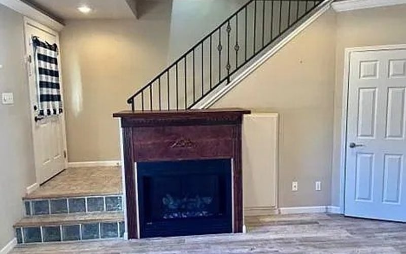 Fireplace with staircase and entry