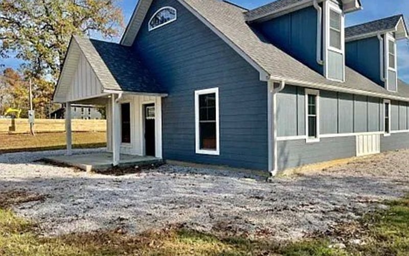 Front exterior with blue-grey siding and covered porch