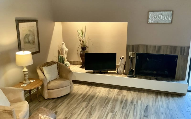 Living room TV wall with fireplace and Gather sign