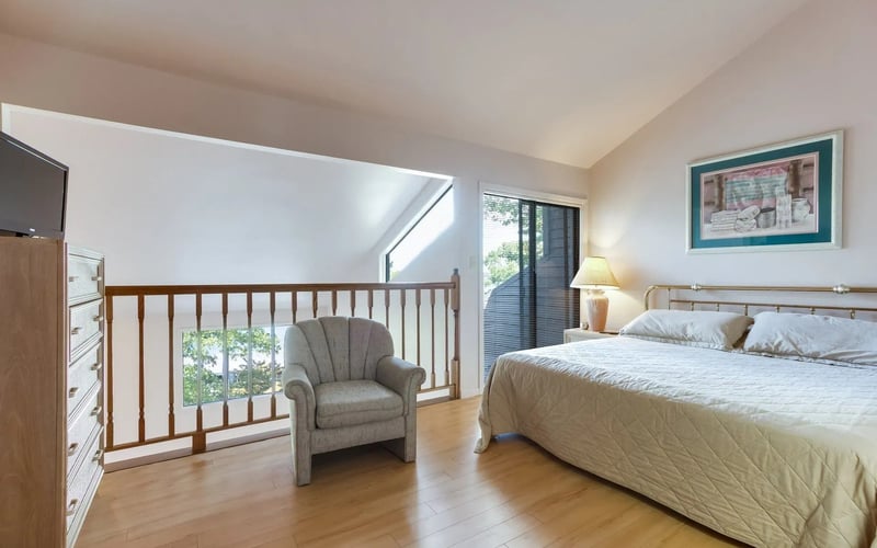 Master bedroom with loft railing and lake view