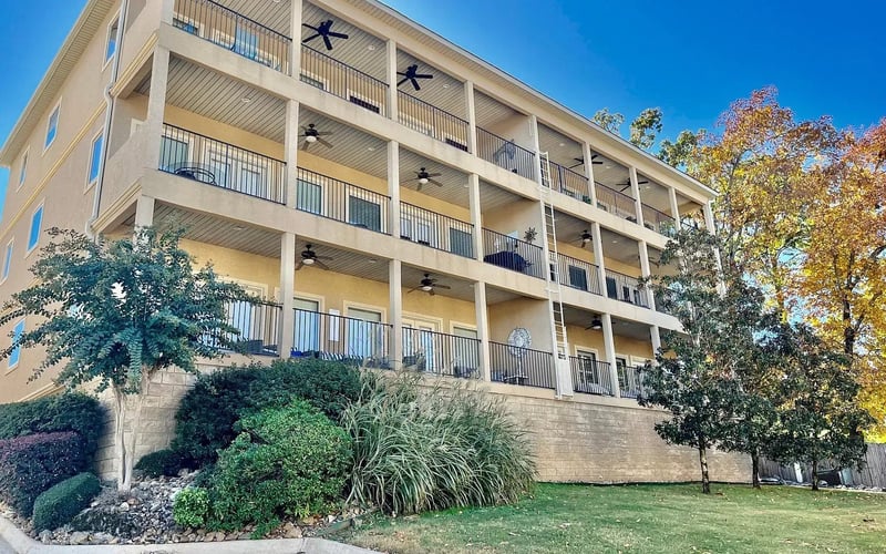 Building B with stacked balconies and fall foliage