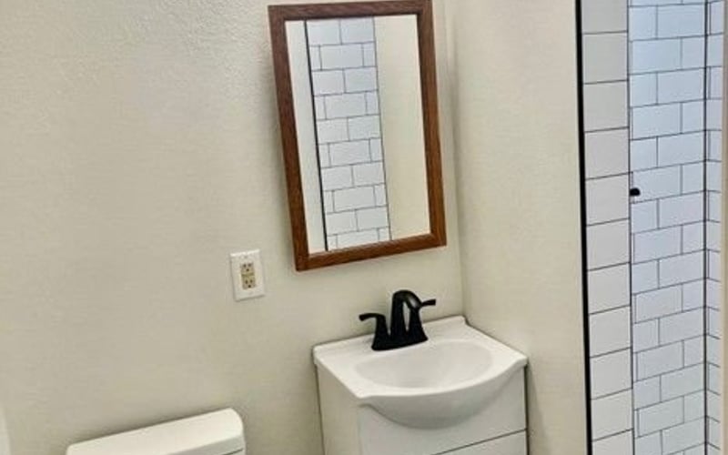 Bathroom with vanity and subway tile shower