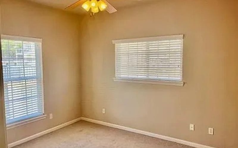 Bedroom with ceiling fan and two windows