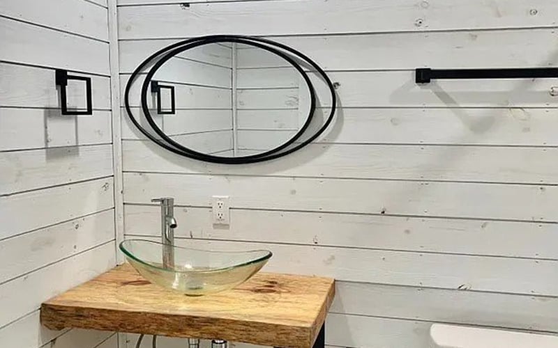 Bathroom vanity with vessel sink and shiplap walls