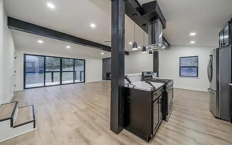 Open kitchen and living area with exposed beams