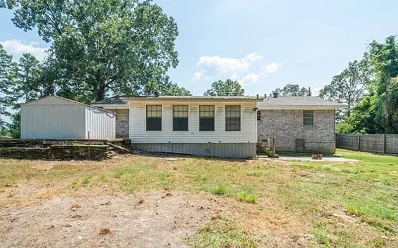Rear exterior with storage shed and backyard