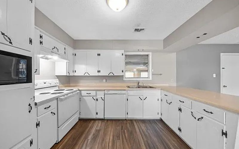 Kitchen with white cabinets and appliances