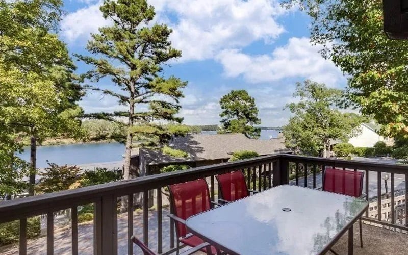 Balcony with red chairs and lake view