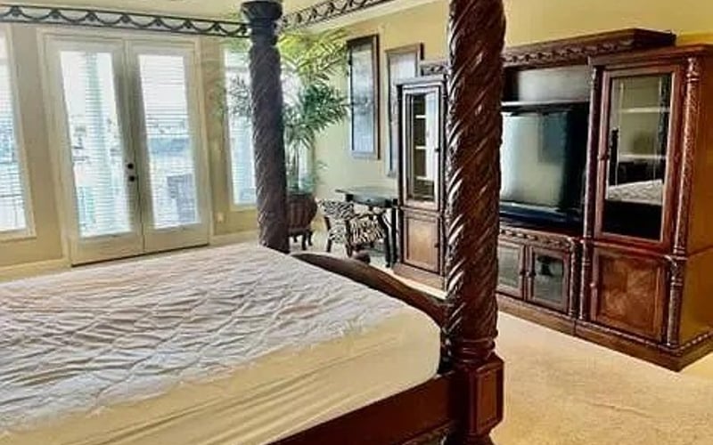 Master bedroom four-poster with entertainment center