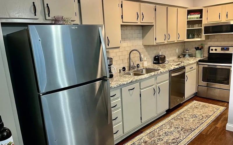 Kitchen with stainless appliances and subway tile