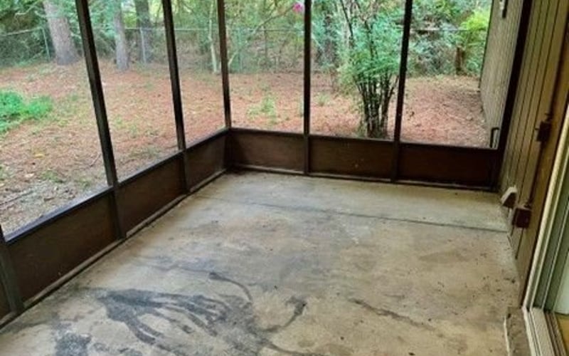 Screened porch with concrete floor and wooded view