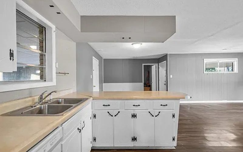 Kitchen with white cabinets and double sink