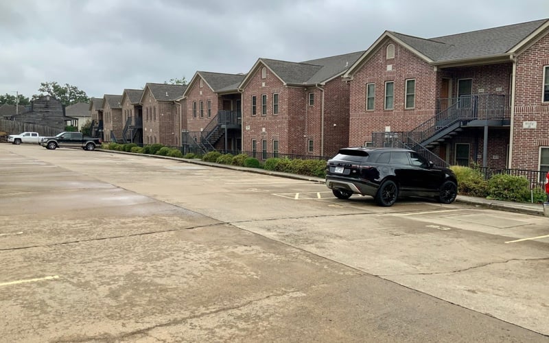 Brick condo buildings with parking lot