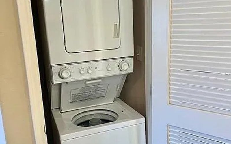 Stacked washer and dryer in closet