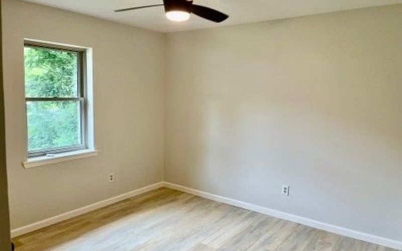 Bedroom with ceiling fan and two windows