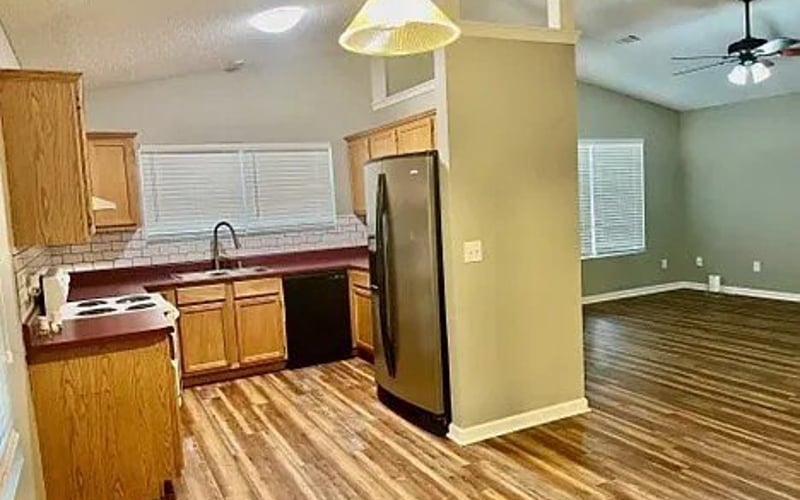 Kitchen with oak cabinets and stainless refrigerator
