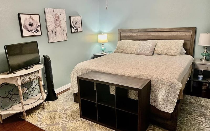 Master bedroom with TV and floral art