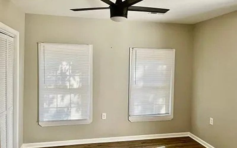 Bedroom with ceiling fan and hardwood floors