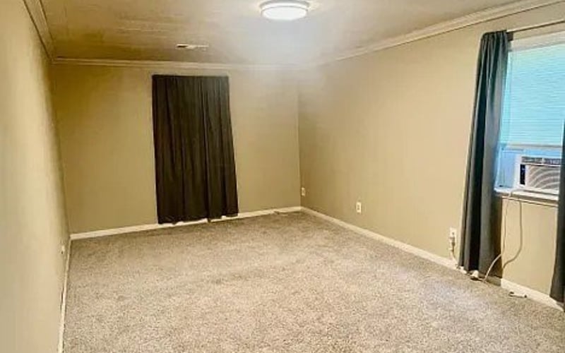 Bedroom with carpet and window AC
