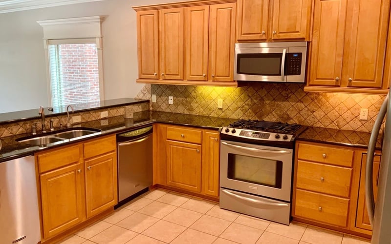 Kitchen with maple cabinets, granite counters, and stainless appliances