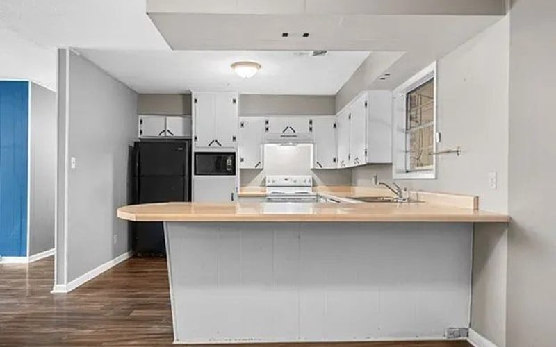Kitchen with peninsula counter and white cabinets