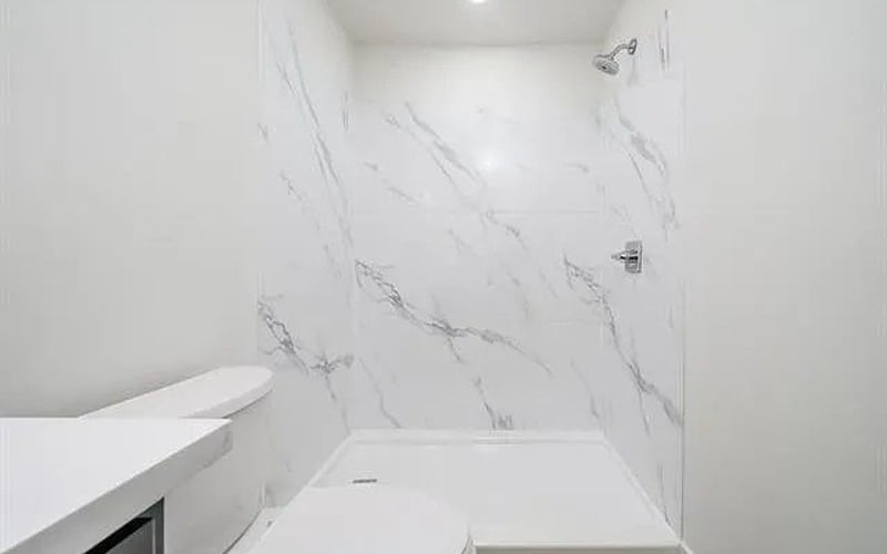 Marble tile shower with chrome fixtures