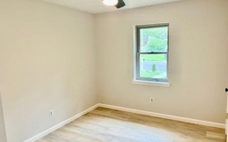 Bedroom with ceiling fan and window
