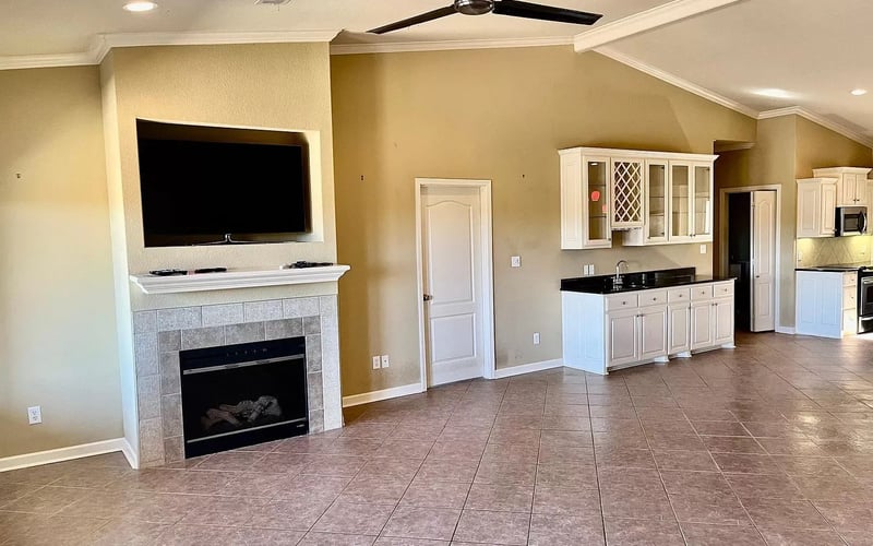 Living room with fireplace, TV, and wet bar