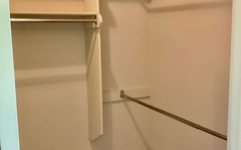 Walk-in closet with shelving and hanging rods