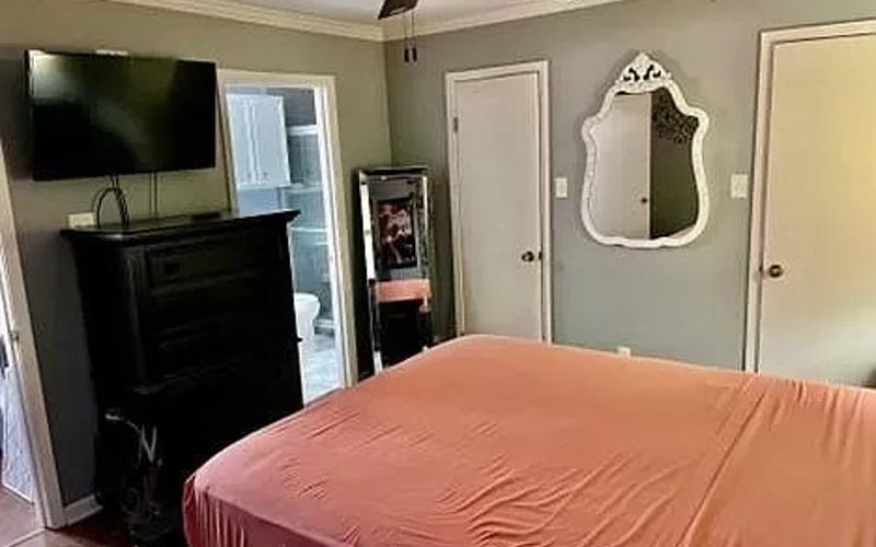Master bedroom with TV and mirror