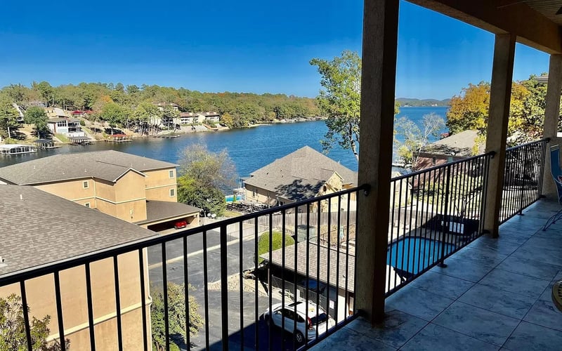 Balcony with wide lake view and pool below