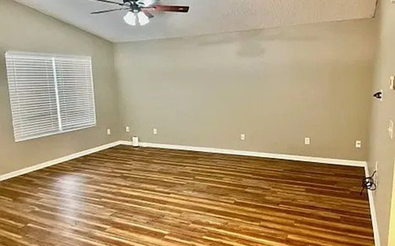 Living room with hardwood floors and ceiling fan