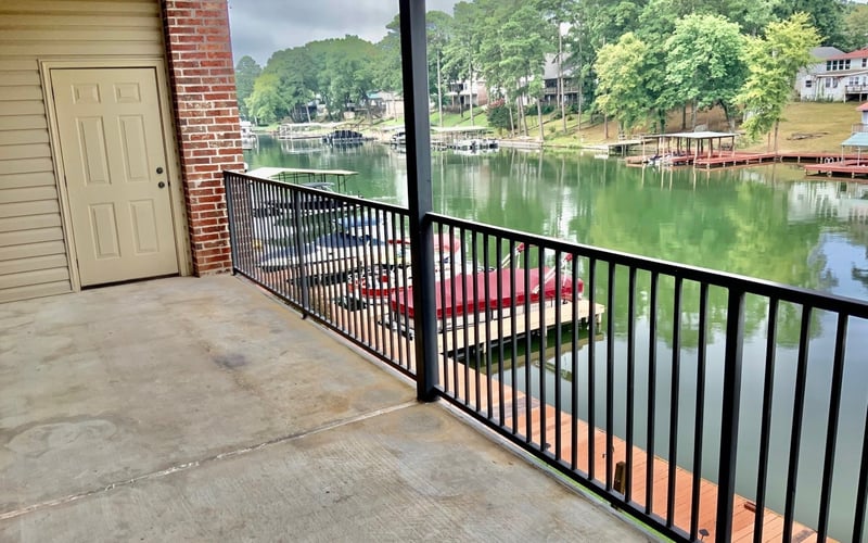 Covered balcony overlooking lake with boat docks