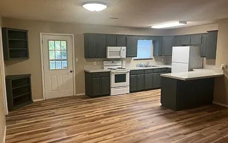 Kitchen with dark cabinets and hardwood floors