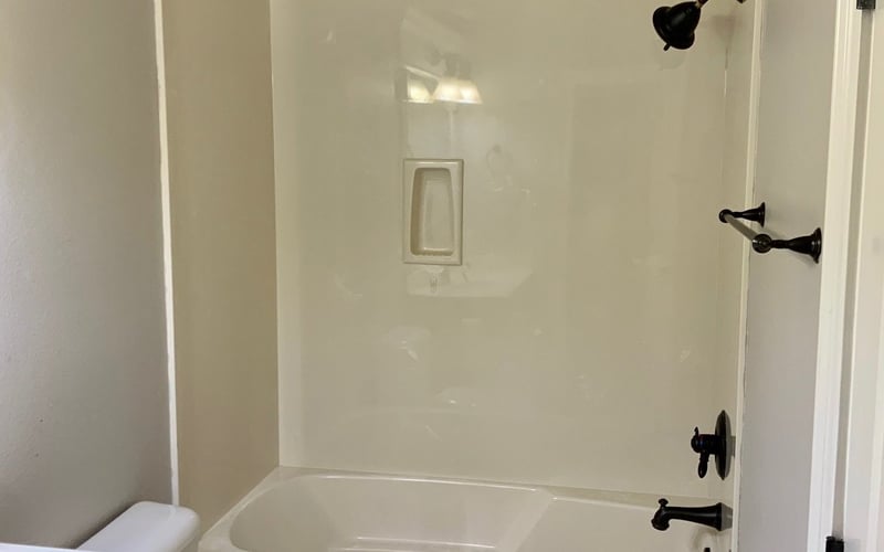 Bathroom with tub/shower combo and oil-rubbed bronze fixtures