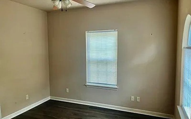 Second bedroom with ceiling fan and hardwood floors