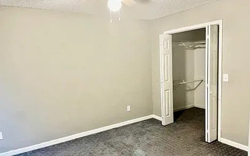 Bedroom with carpet and closet