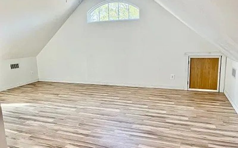 Upstairs loft with vaulted ceiling and hardwood floors