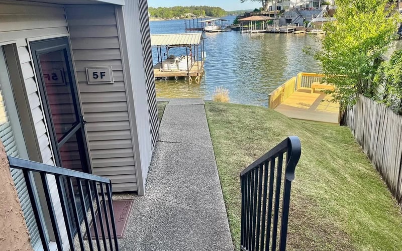 Unit 5F entrance with lawn and boat dock