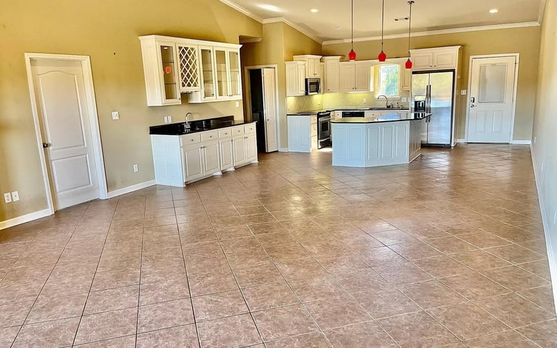 Open floor plan with kitchen island and red pendant lights
