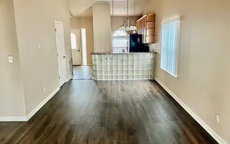 Wide living area view with kitchen bar and pendant lights
