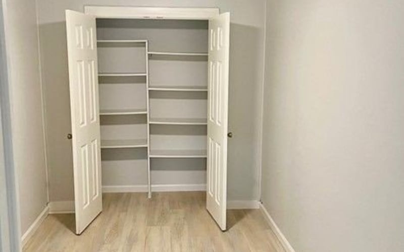 Bedroom with open closet and ceiling fan