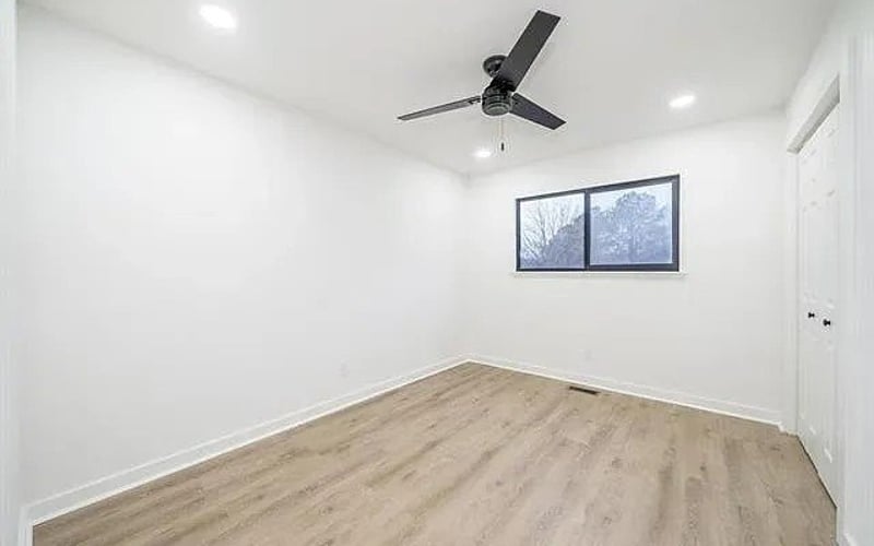 Bedroom with ceiling fan and window