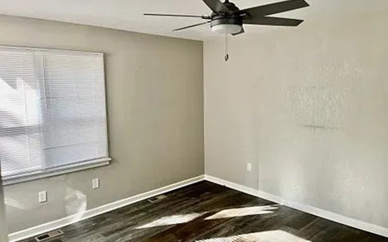 Bedroom with ceiling fan and windows