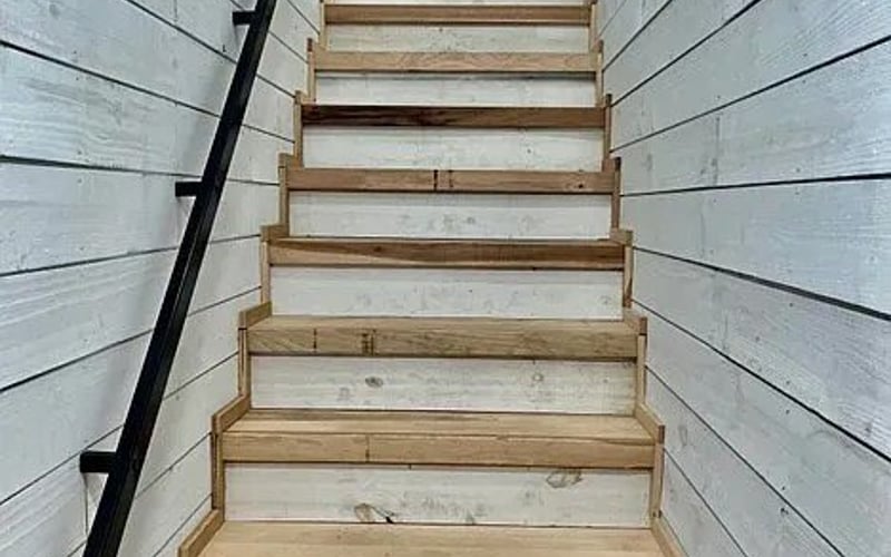 Staircase with shiplap walls and wood treads