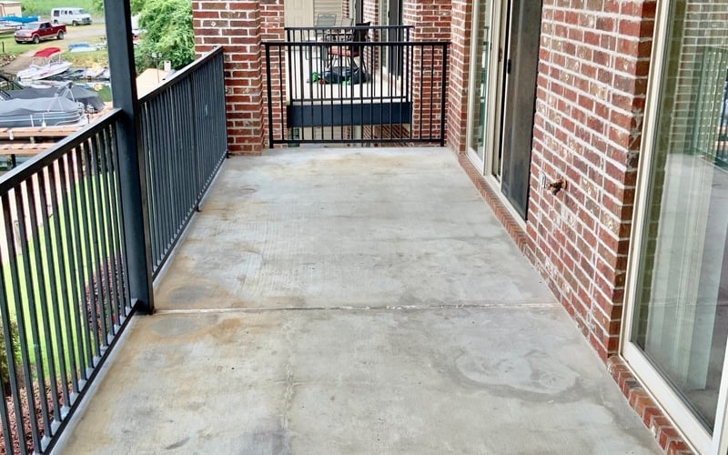 Long covered balcony with brick exterior and lake views