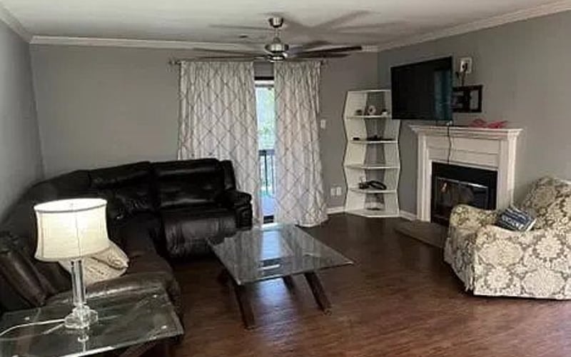 Living room with fireplace and TV