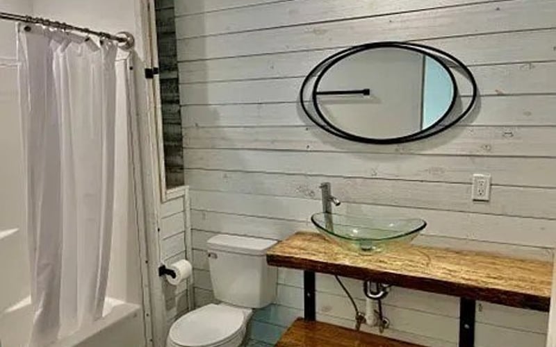 Bathroom with vessel sink and shiplap walls