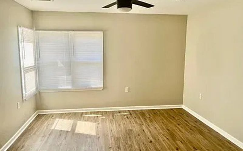 Bedroom with ceiling fan and window
