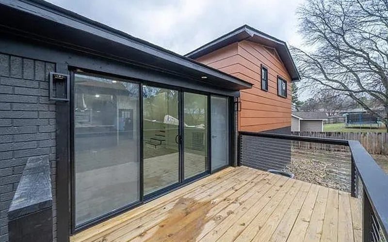 Deck with sliding glass doors and cedar siding
